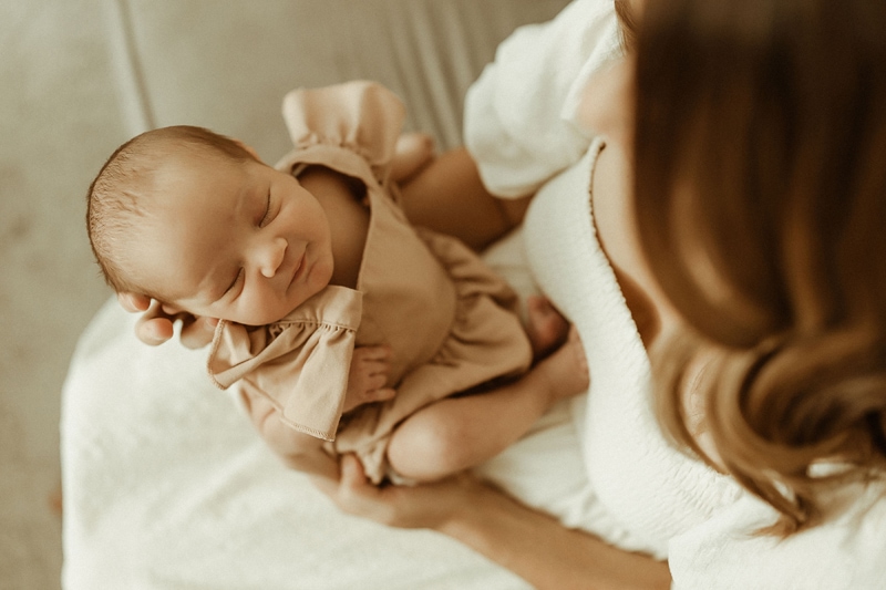 Newborn Photography, mom holding smiling newborn baby