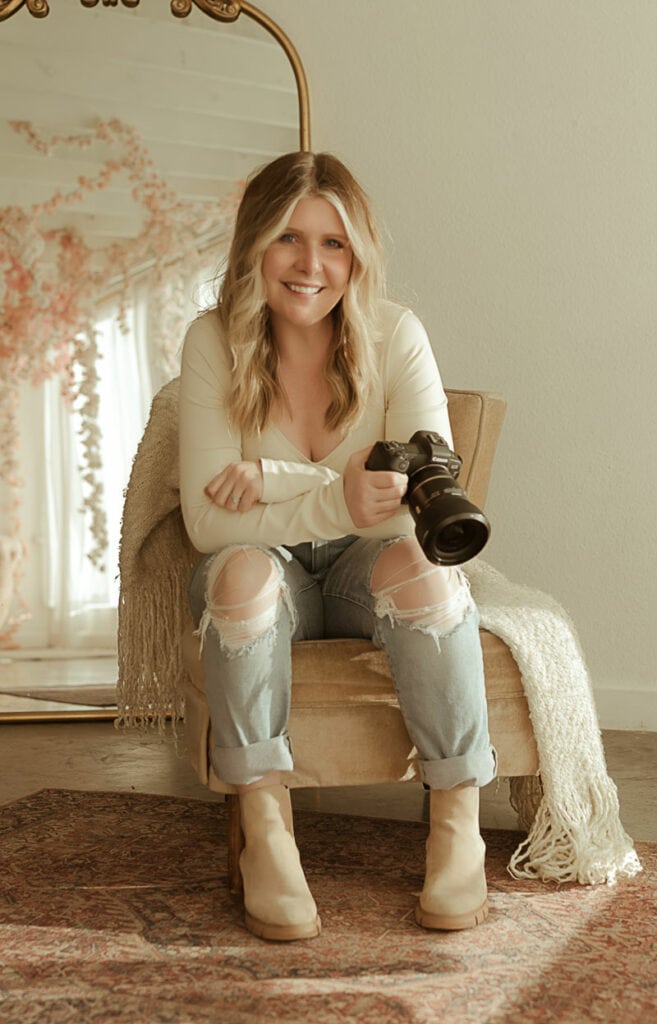 Newborn Photography, photo of the photographer holding her camera and smiling